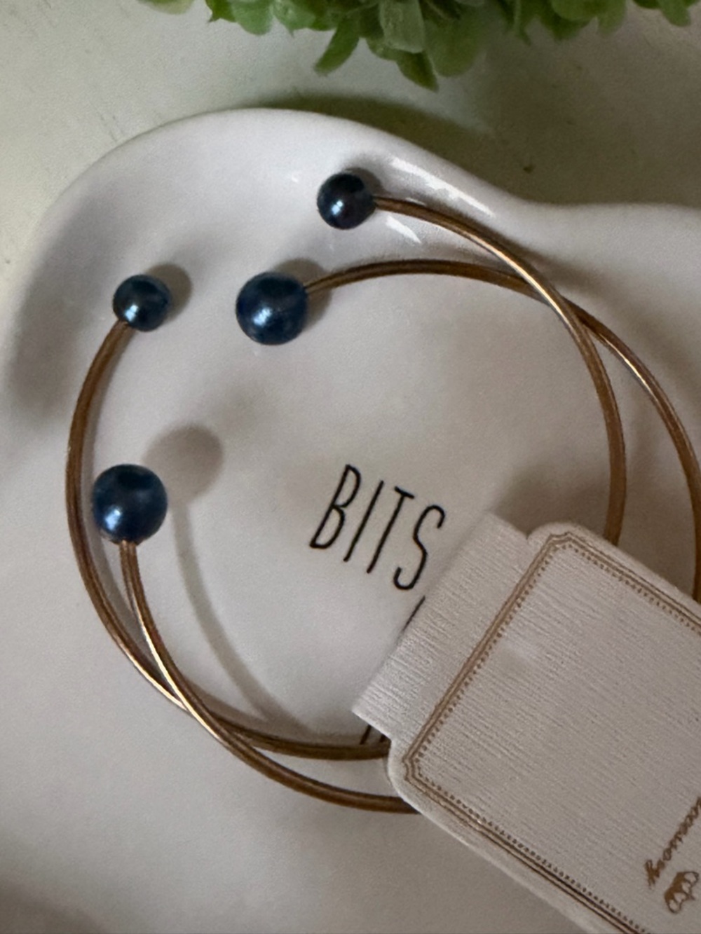 Free with purchase Gold tone open bracelet with blue pearl accent